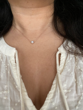 Load image into Gallery viewer, Dainty single white freshwater pearl on a pink silk cord. Picture shows the necklace worn.
