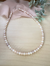 Load image into Gallery viewer, Layering necklace made of pink and white alternating freshwater Pearl beads with a 2 inch extender chain. 