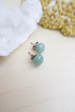 Load image into Gallery viewer, 8mm Sea Green Aventurine on surgical steel posts sitting on a table 
