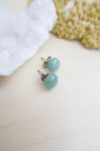 8mm Sea Green Aventurine on surgical steel posts sitting on a table 
