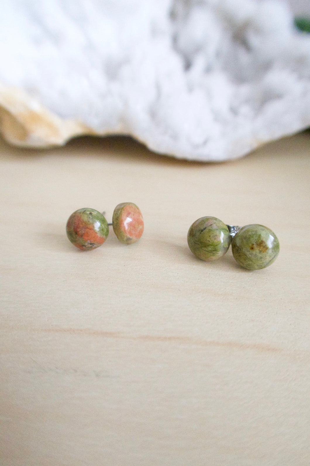 Green and pink gemstone studs on surgical steel posts