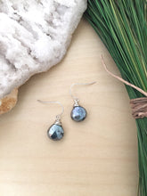 Load image into Gallery viewer, Metallic black gemstone drop earrings with sterling silver ear wires set on a table 