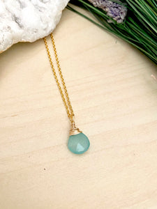 Aquablue chalcedont gemstone wire wrapped in gold fill wire and suspended from a gold chain 