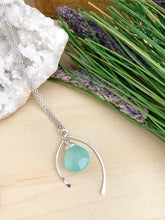 Load image into Gallery viewer, Aqua Blue Chalcedony pendant anclosed in a sterling silver wishbone frame and suspended from a 16 inch chain 